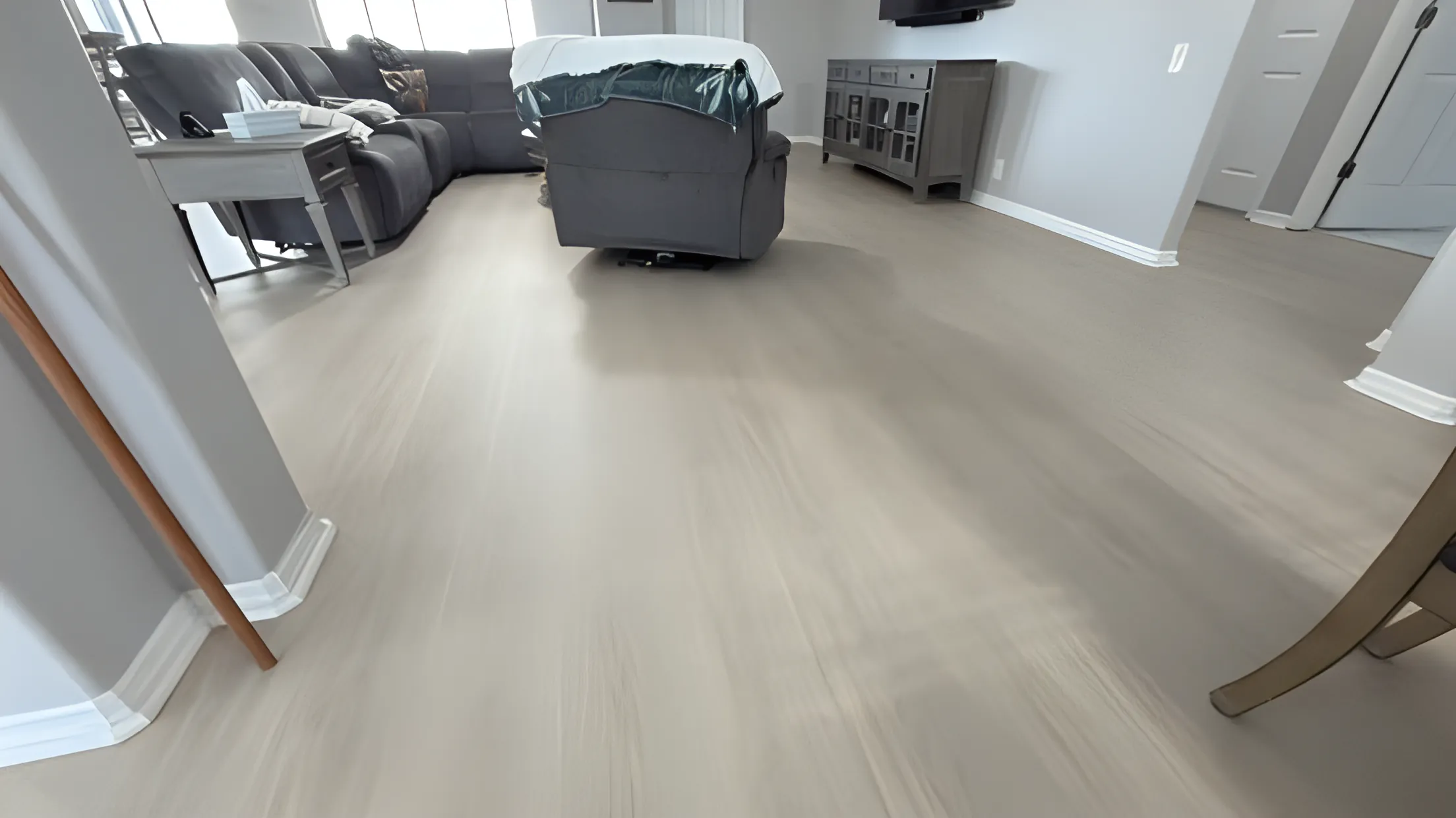 Light gray vinyl plank flooring in a combined dining and living area