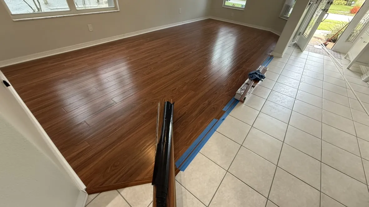 Hardwood flooring meeting tile at a clean transition line