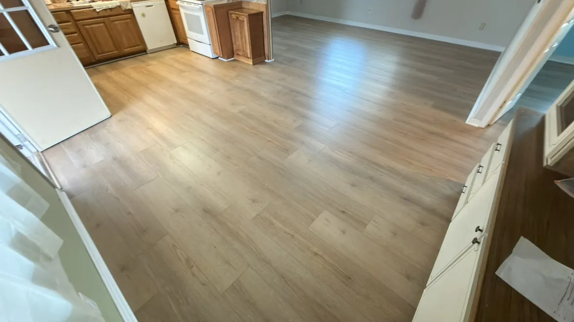 Light vinyl plank flooring installed through a kitchen