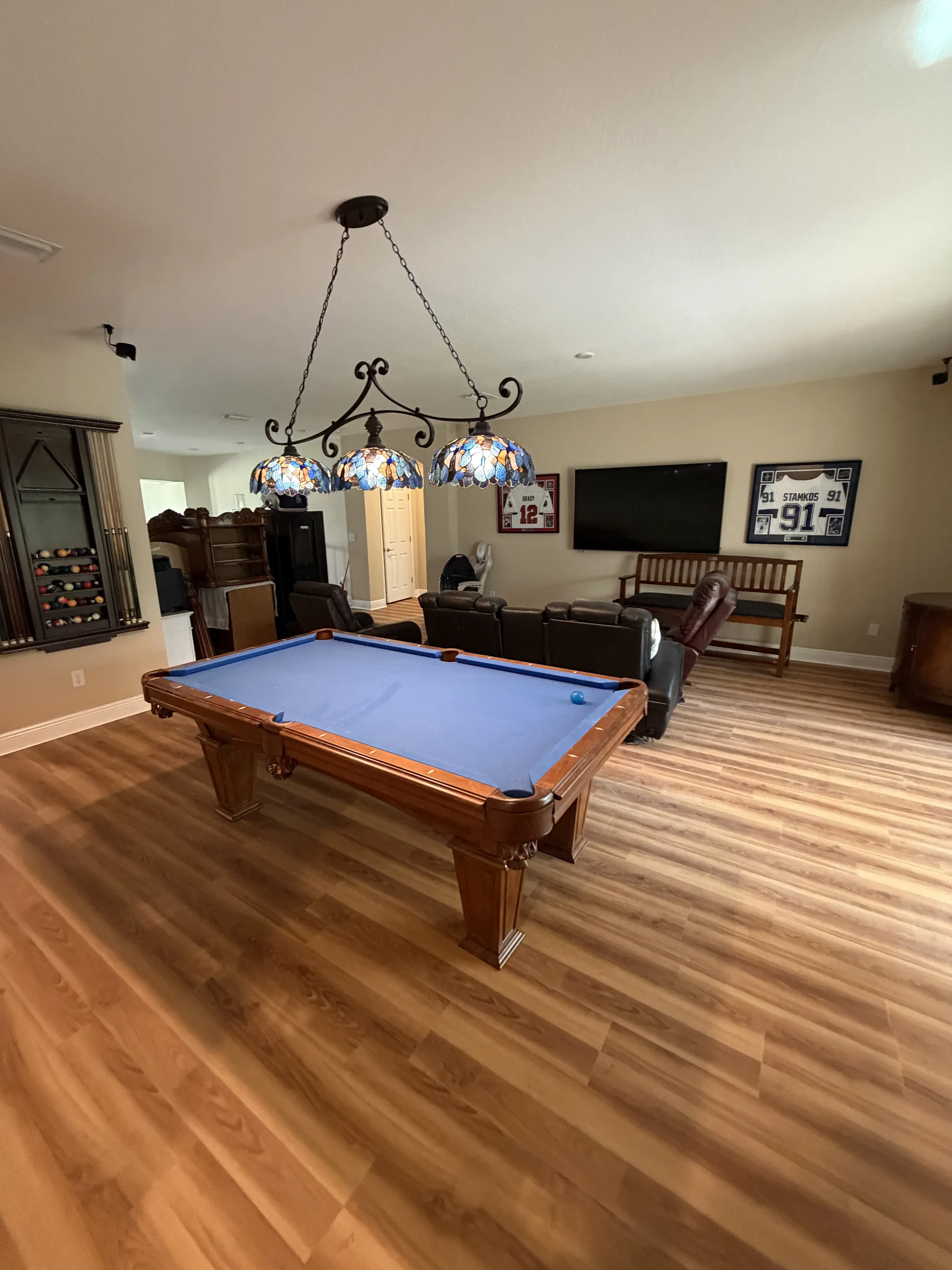 Laminate flooring installed wall to wall in a game room by R.C Galli in Zephyrhills, Florida