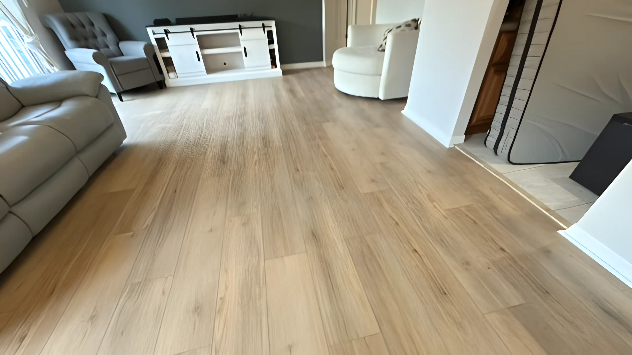Light vinyl plank flooring in a furnished living room
