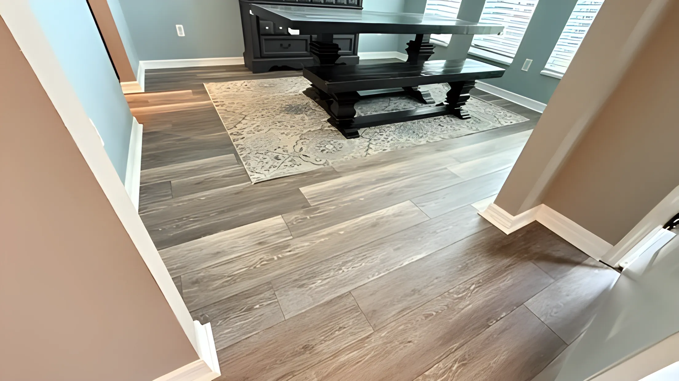 Vinyl plank flooring in a dining room with a patterned rug