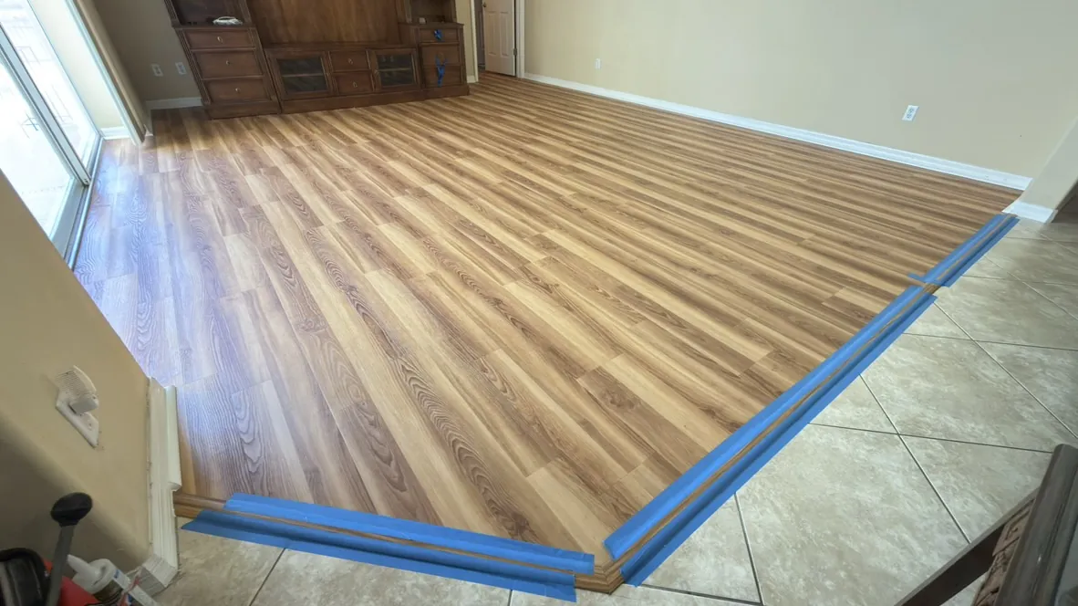 Vinyl plank flooring installed up to a tile transition strip
