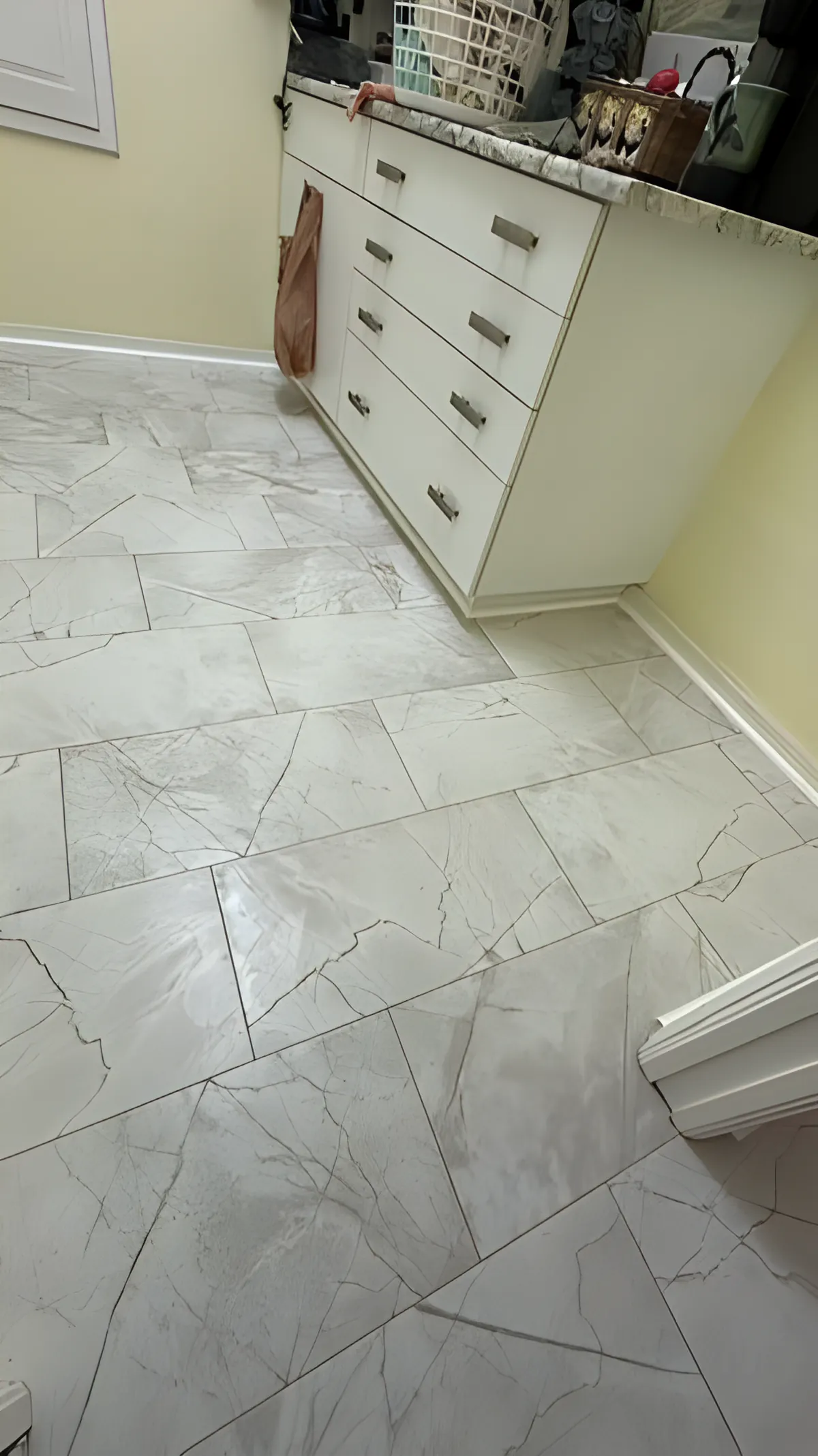 Marble-look tile flooring detail along cabinetry