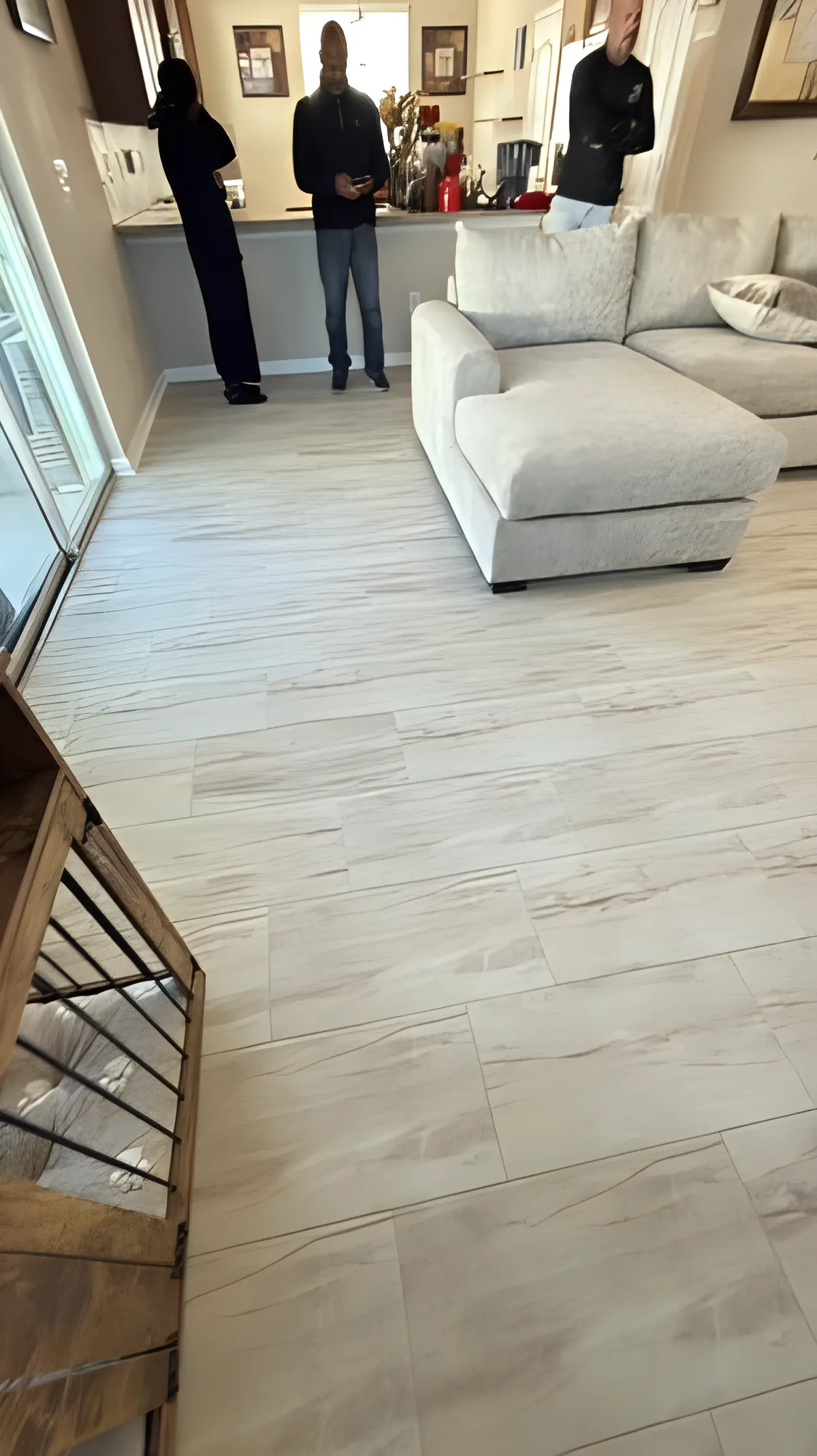 Light oak-tone vinyl plank flooring running through an open concept entry and living room