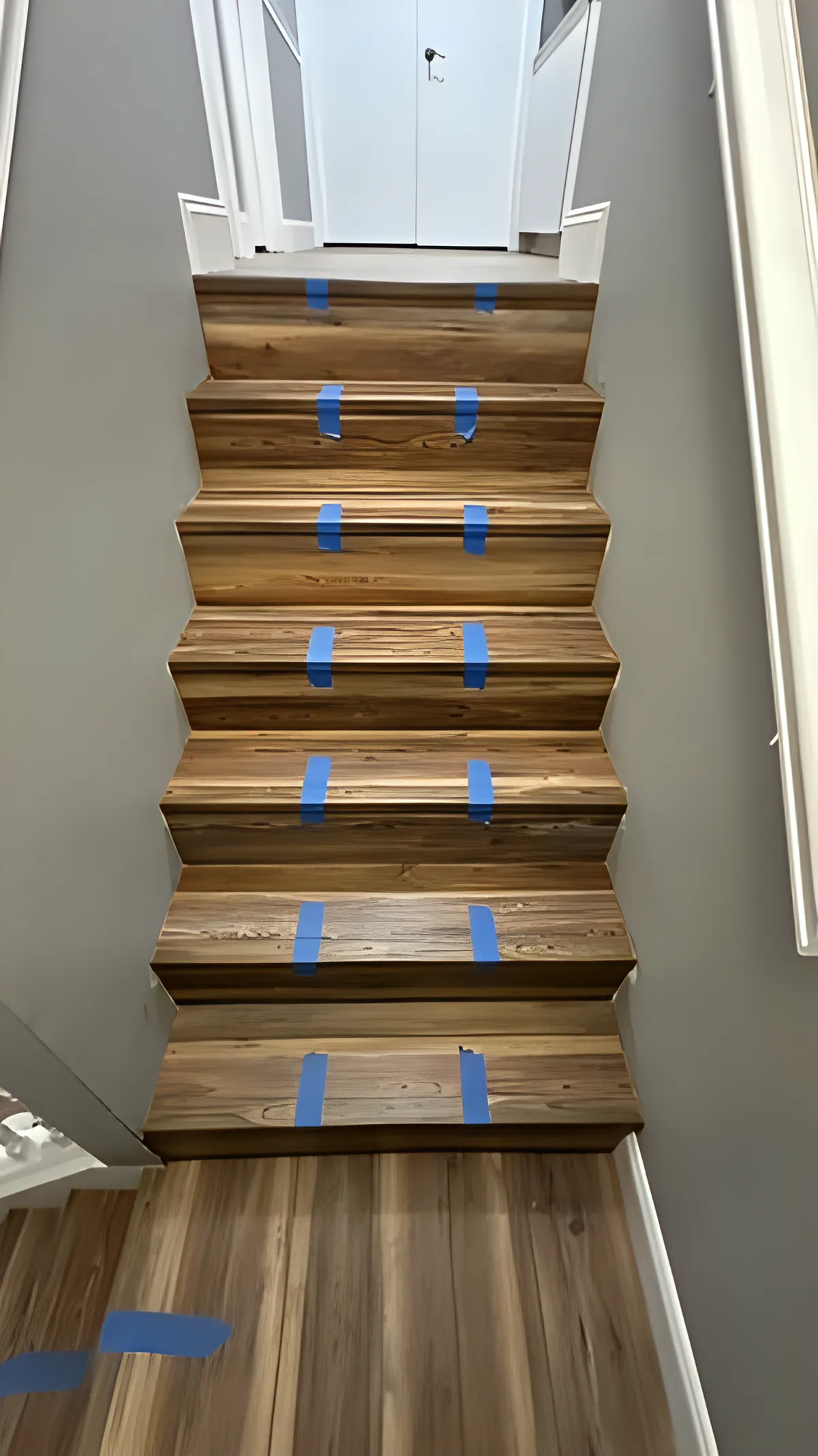 Stair treads taped and curing during installation