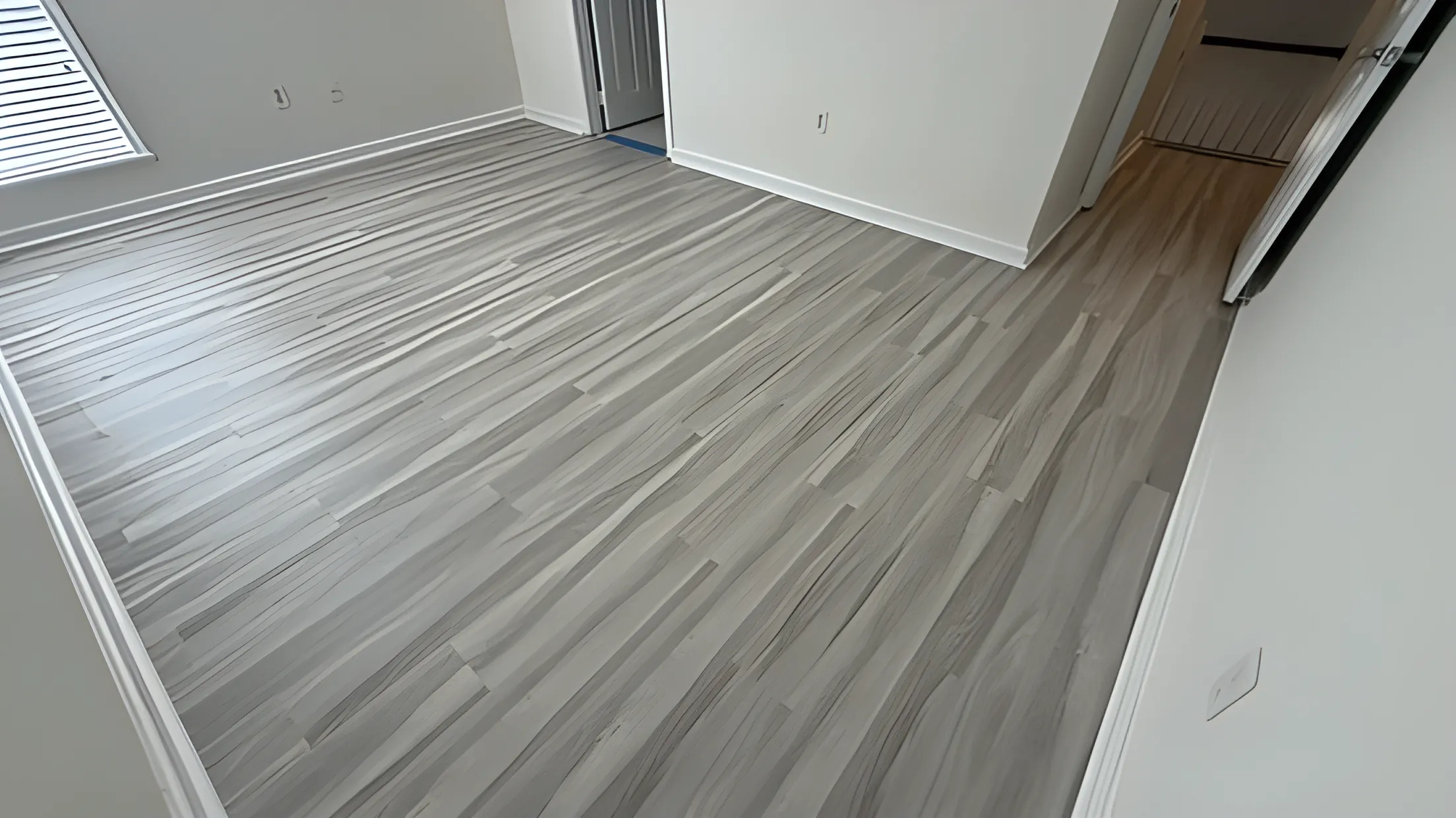 Light gray vinyl plank flooring in an empty room ready for move-in