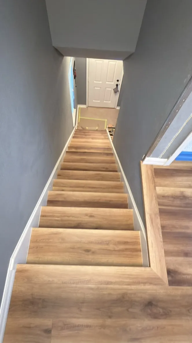 Vinyl plank stair treads leading to a landing