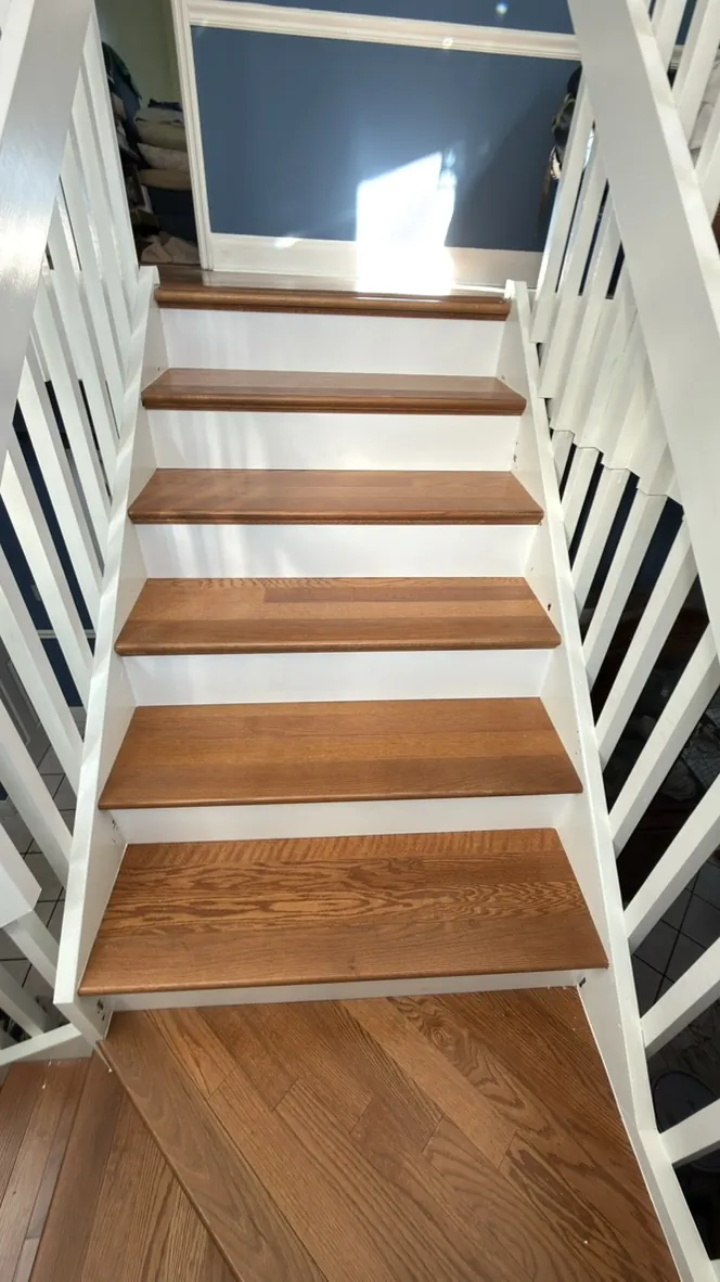 Oak stair treads with a white rail and balusters