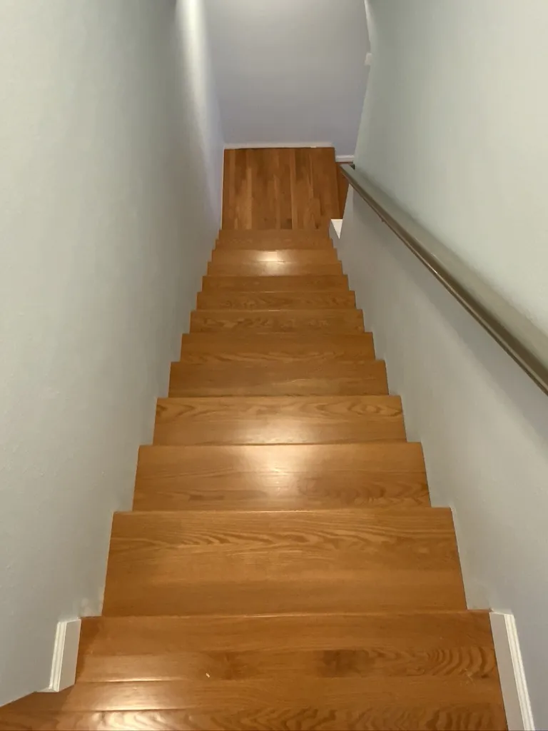 Red oak stair treads with white risers installed on a residential staircase in Pasco County