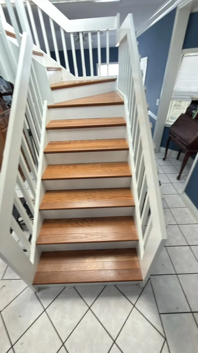 Wood stair treads with white balusters and handrail